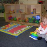 East Riverside KinderCare Photo - Our infants are busy working on problem solving and hand-eye coordination with the stacking rings in the classroom.