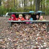 The Childrens House, Inc. Photo - Leaf fort!! Hiding out with Isa, Liam, Riley, Fisher, Eva, and Teo!