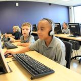 The Rock Academy Photo - Elementary students enjoy interactive learning in the state of the art computer lab.